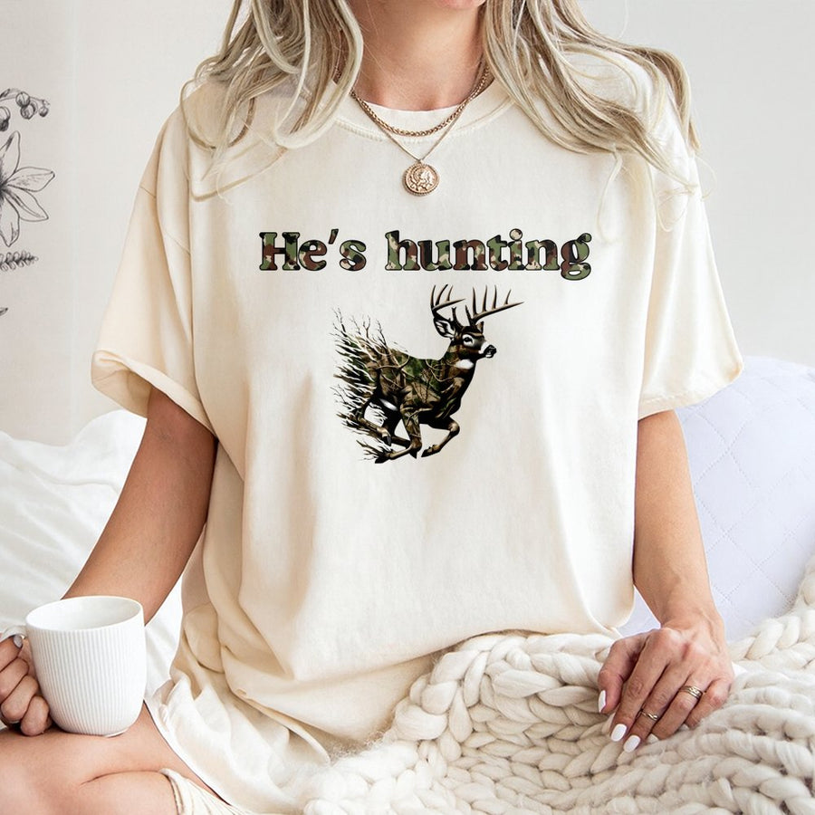 He's Hunting Deer T-Shirt | Camo Whitetail Buck Graphic | Premium 100% Cotton | Gift for Hunters and Outdoorsmen