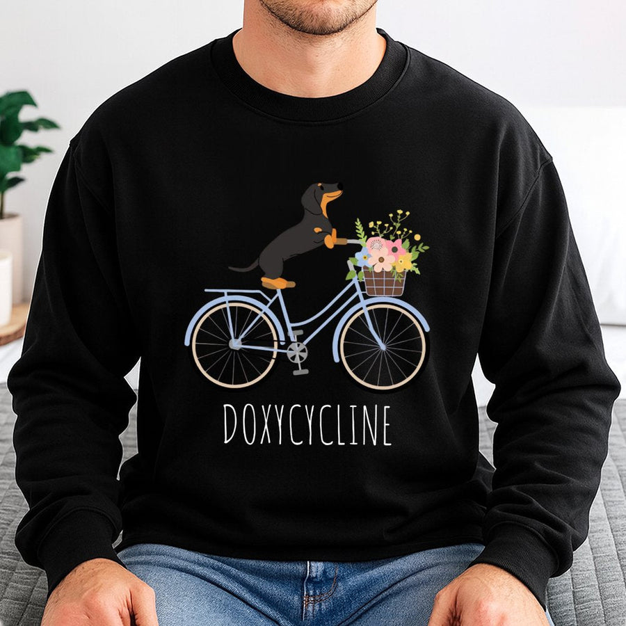 Doxycycline Pharmacy Pun Sweatshirt | Cute Dachshund Riding Bicycle Graphic | Premium Cotton Blend | Funny Gift for Pharmacists and Vet Techs