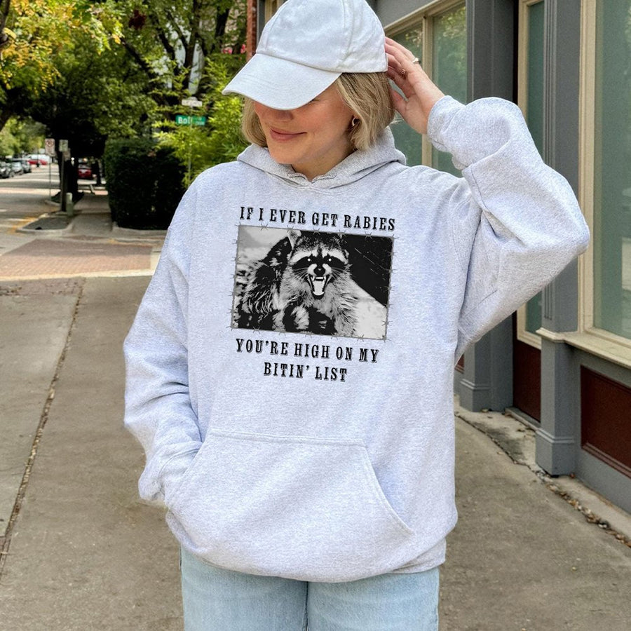 Raccoon Hoodie | Funny Rabies Bitin' List Graphic Print | Premium Cotton-Poly Blend | Unisex Gift for Wildlife Lovers
