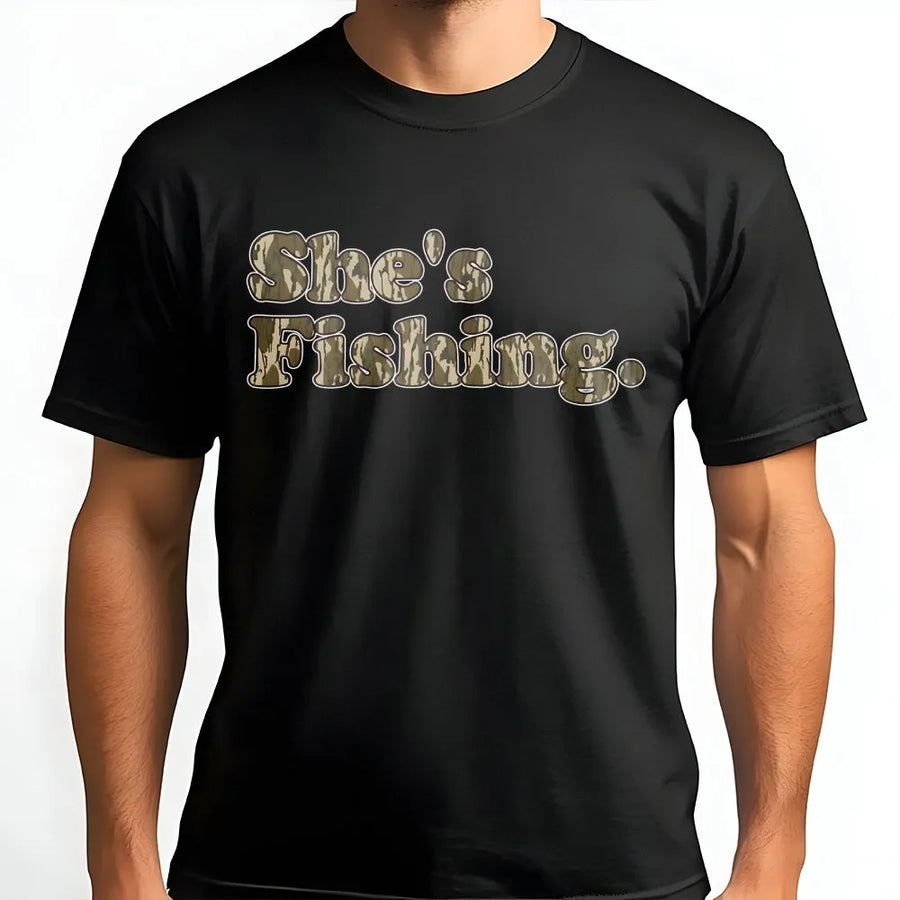 She's Fishing Camo T-Shirt | Retro Woodland Font Design | Premium 100% Cotton | Women's Outdoor Apparel and Fishing Gift for Her