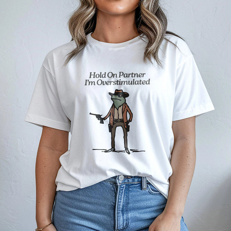 Hold On Partner I'm Overstimulated T-Shirt | Funny Cowboy Frog Graphic Tee | Premium 100% Cotton Apparel | Humorous Gift for Neurodivergent Friends
