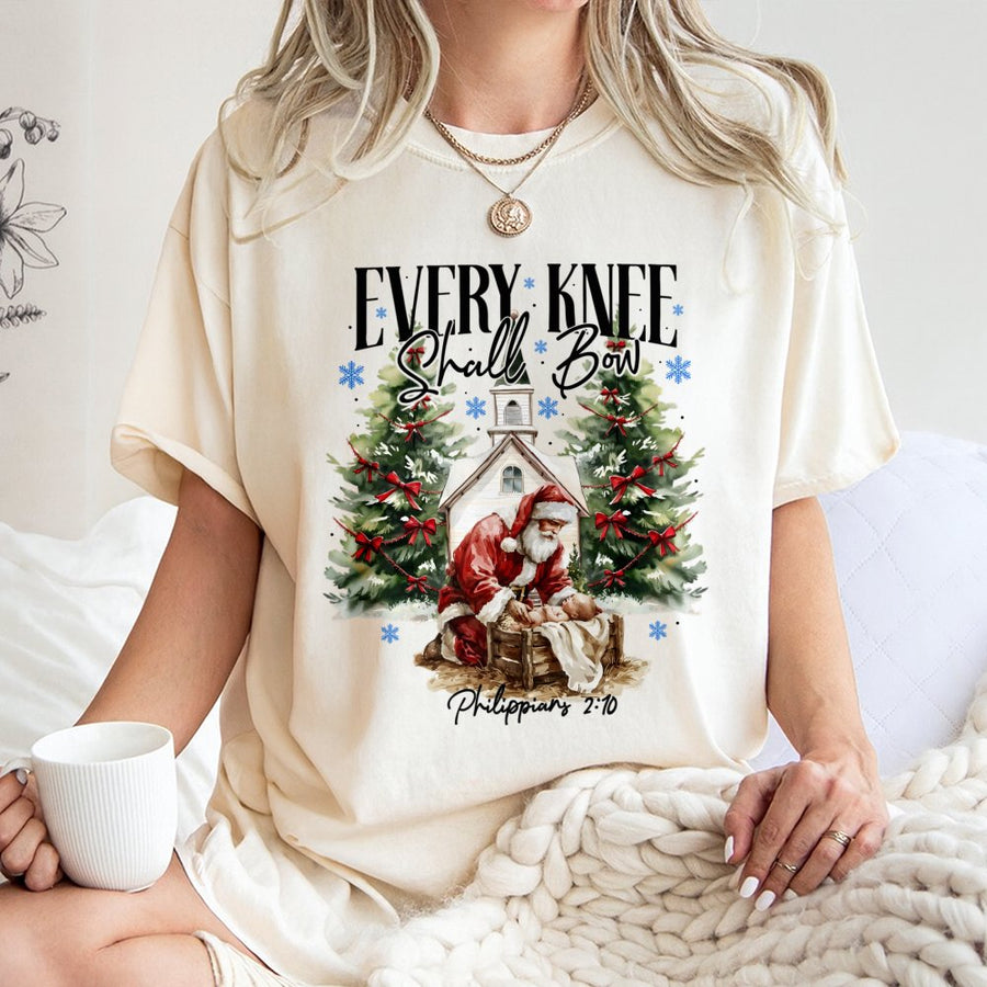 Every Knee Shall Bow T-Shirt | Santa Kneeling Before Baby Jesus | 100% Cotton Religious Christmas Graphic Tee | Meaningful Faith-Based Holiday Gift