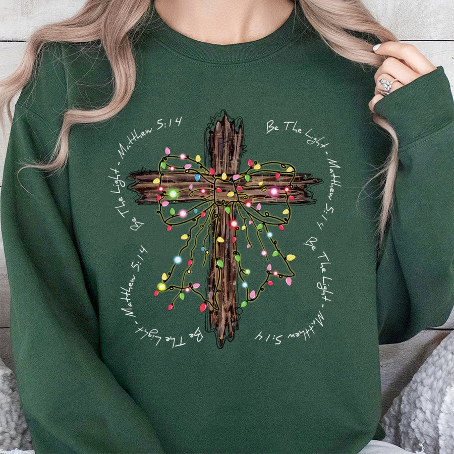 Be The Light Sweatshirt | Rustic Christmas Cross with Lights | Premium Cotton Blend | Christian Bible Verse Gift for Women and Men