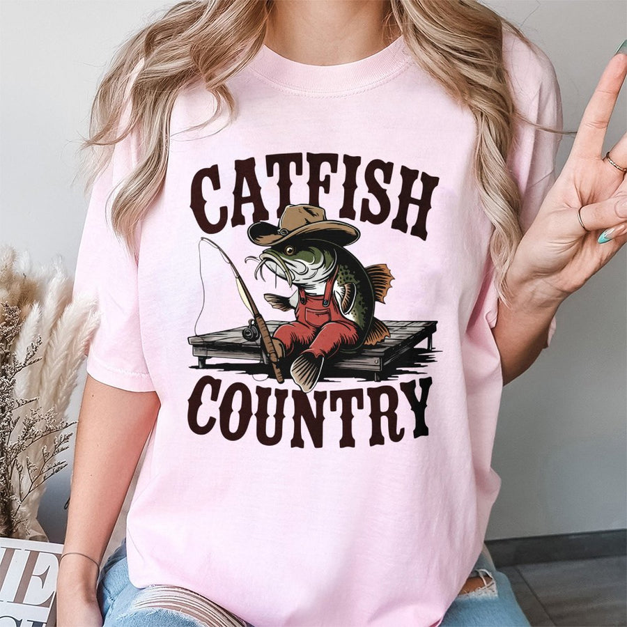 Catfish Country Fishing T-Shirt | Funny Cowboy Catfish Cartoon Graphic | 100% Cotton Premium Tee | Unique Angler Gift for Men and Women