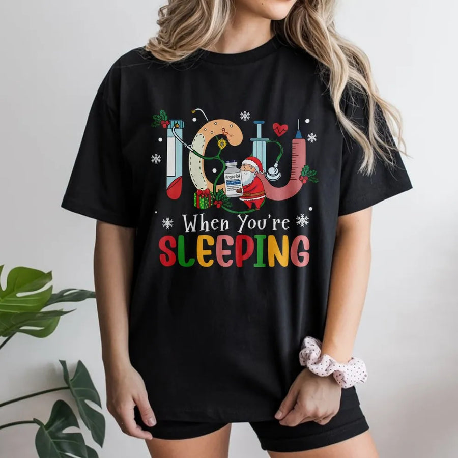 ICU Nurse Christmas T-Shirt | Funny When You're Sleeping Santa Medical Design | Premium Cotton Graphic Tee | Gift for Intensive Care Unit RNs