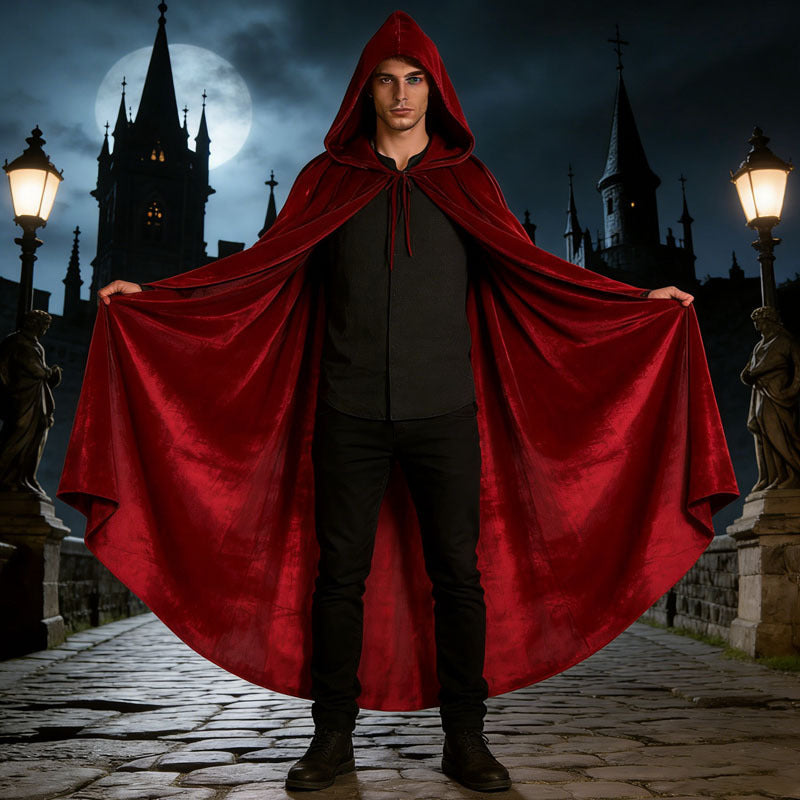 Man wearing the burgundy velvet hooded cloak on a night street