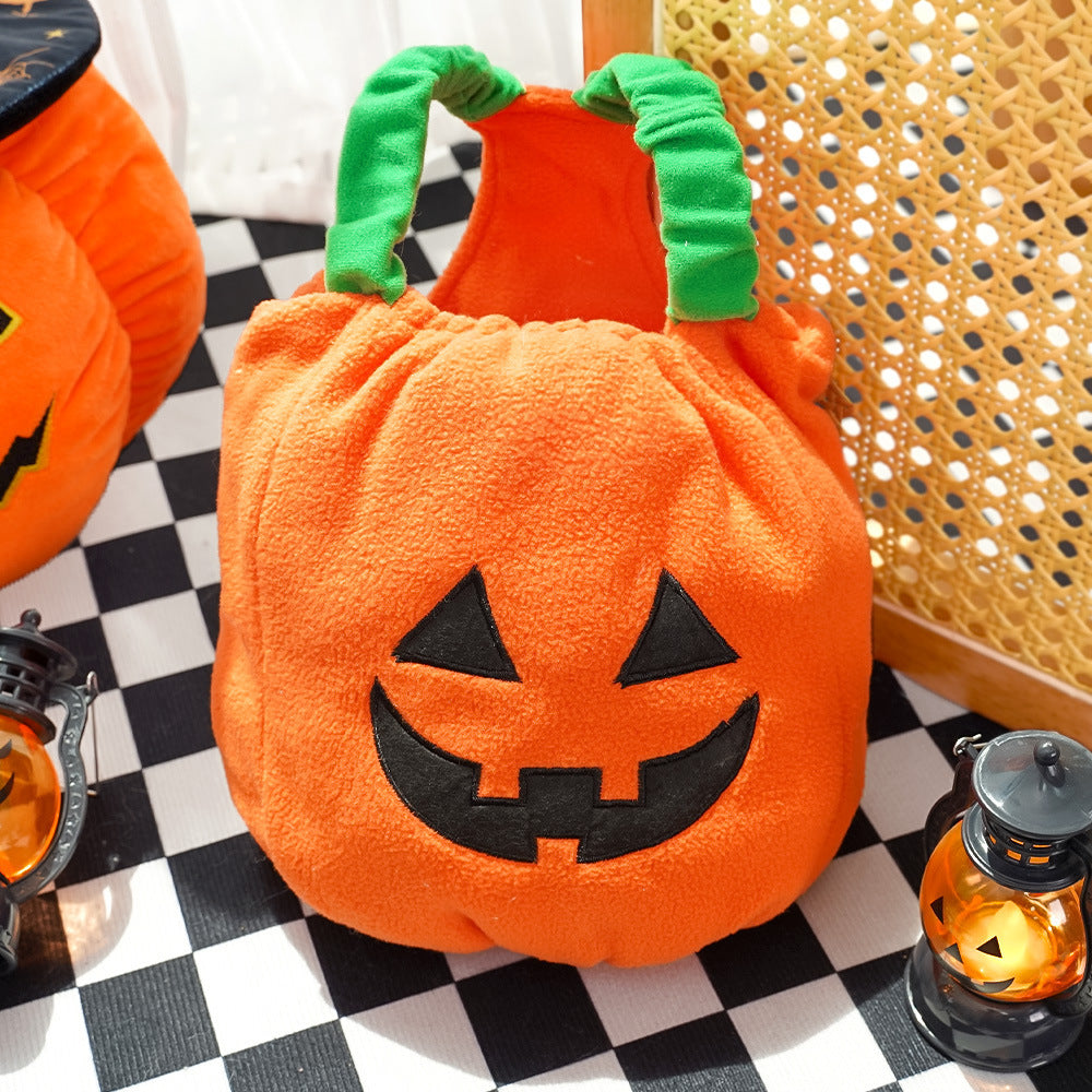 Dog pumpkin costume laid flat, green straps and embroidered face