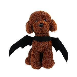 Felt bat wings on a small plush dog
