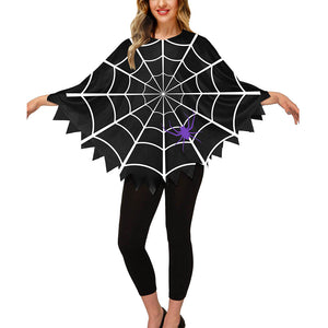 Woman wearing the black spider web poncho with a purple spider, arms out