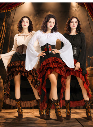 Three women in pirate costumes on a ship-themed set