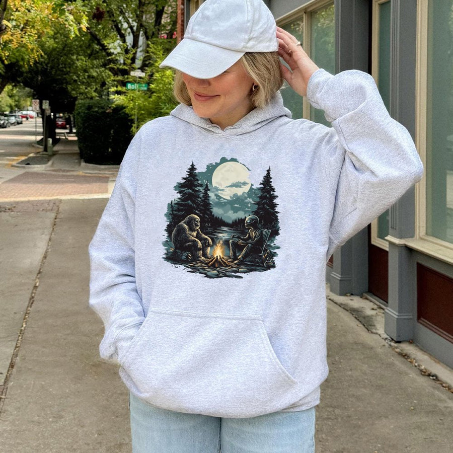 Bigfoot and Alien Hoodie | Campfire Forest Graphic Sweatshirt | Premium Cotton-Blend Pullover | Funny Cryptid Lover Gift for Men and Women