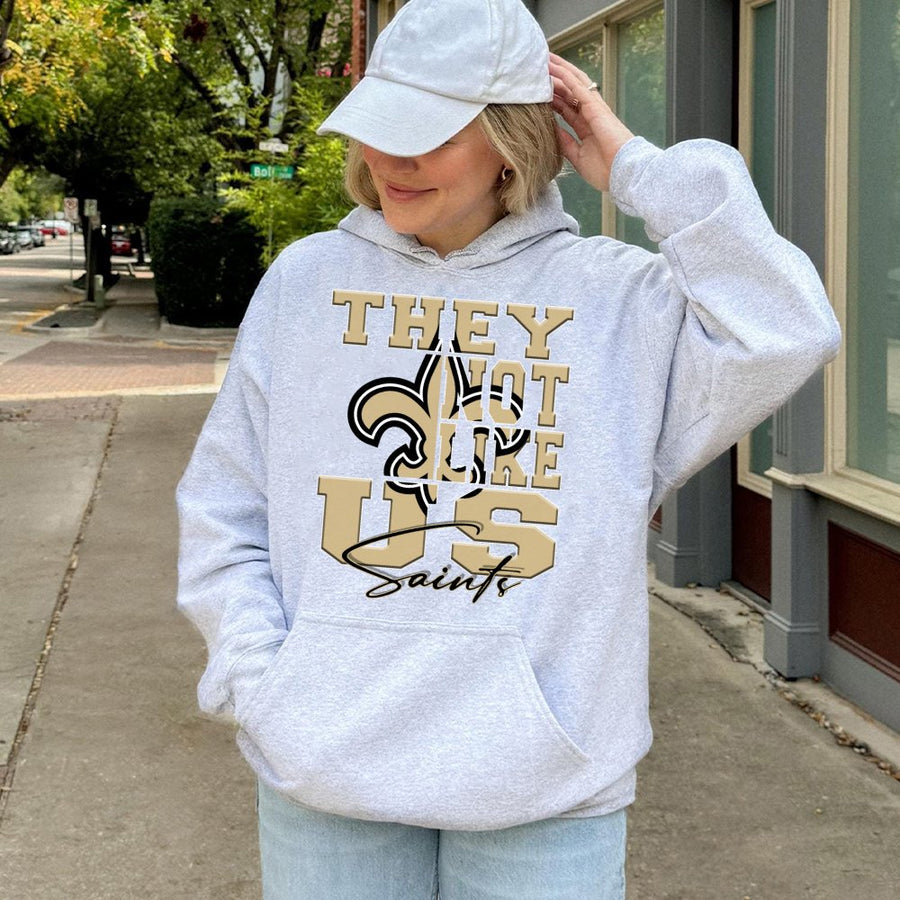 They Not Like Us Saints With New Orleans Saints Fleur-De-Lis Logo Hoodie
