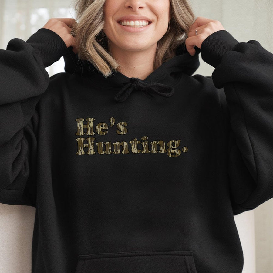 He's Hunting Hoodie | Retro Camo Lettering Graphic Sweatshirt | Cotton-Polyester Blend | Trendy Outdoor Gift for Hunters and Outdoorsmen