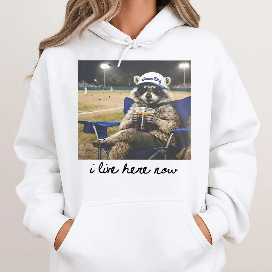 I Live Here Now Raccoon Shirt | Funny Travel Ball Parent Life Meme | Soft 100% Cotton Tee | Gift for Baseball Mom or Softball Dad