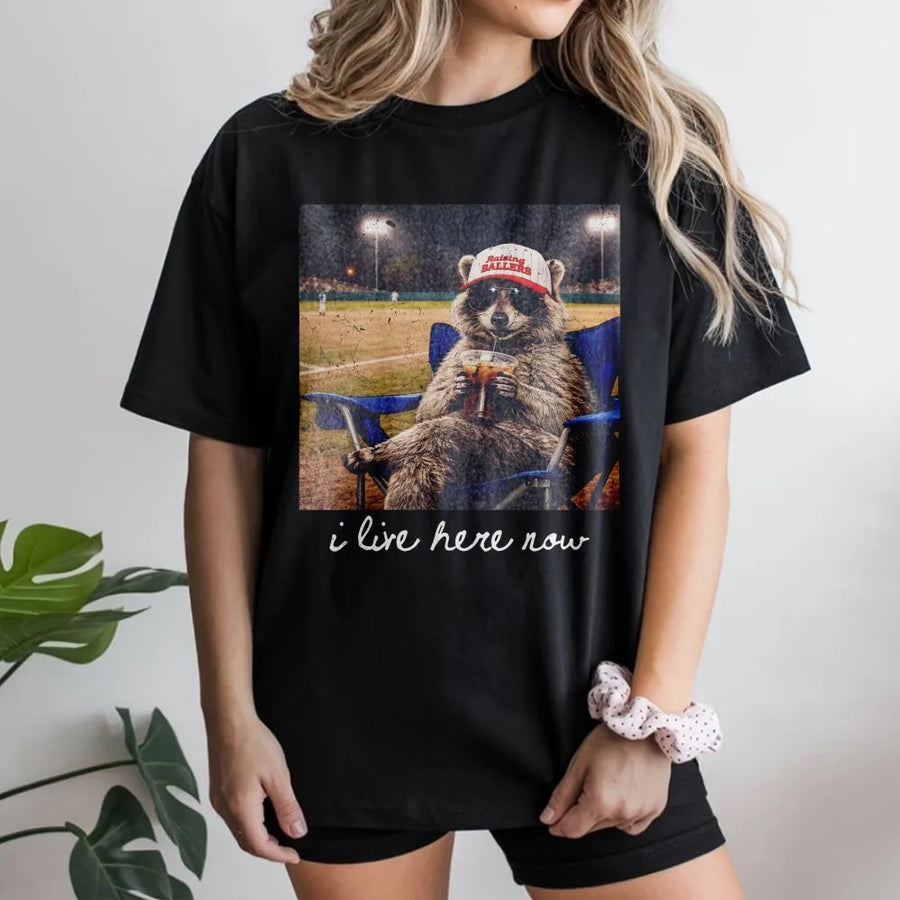 Funny Raccoon Baseball Mom T-Shirt | I Live Here Now Vintage Ballpark Graphic | Premium Cotton Blend | Gift for Softball Mama