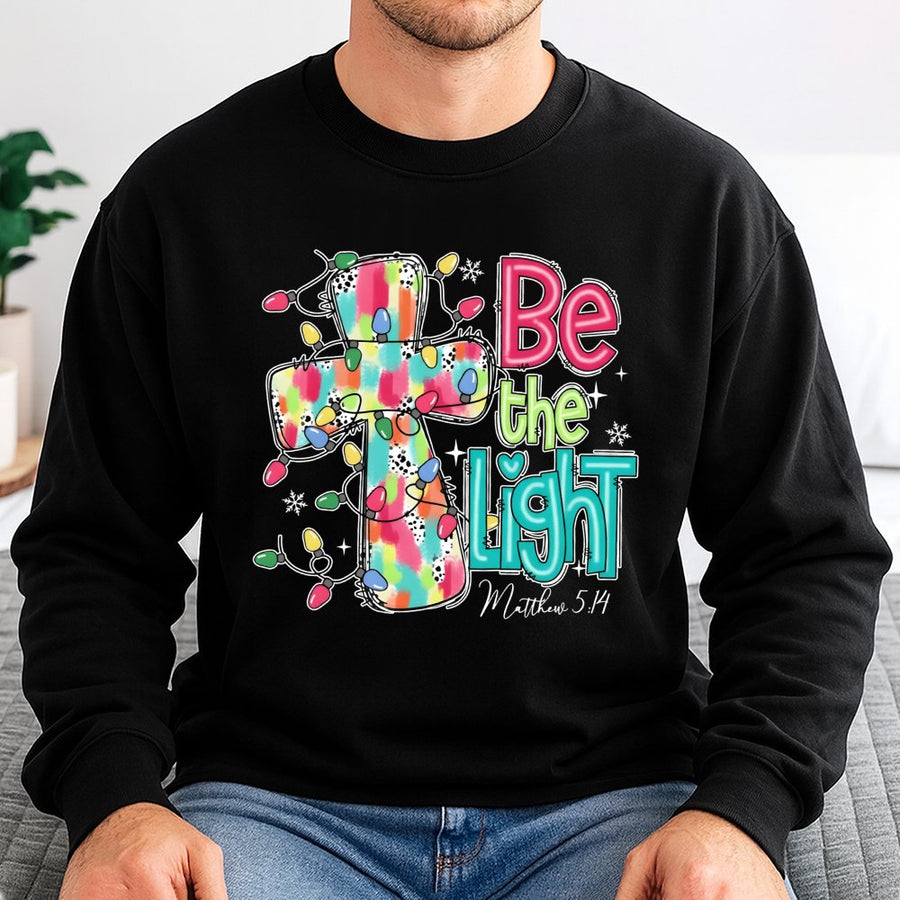 Be The Light Sweatshirt | Christmas Cross Bible Verse Design | Premium Cotton Blend | Faith-Based Holiday Gift for Women and Men