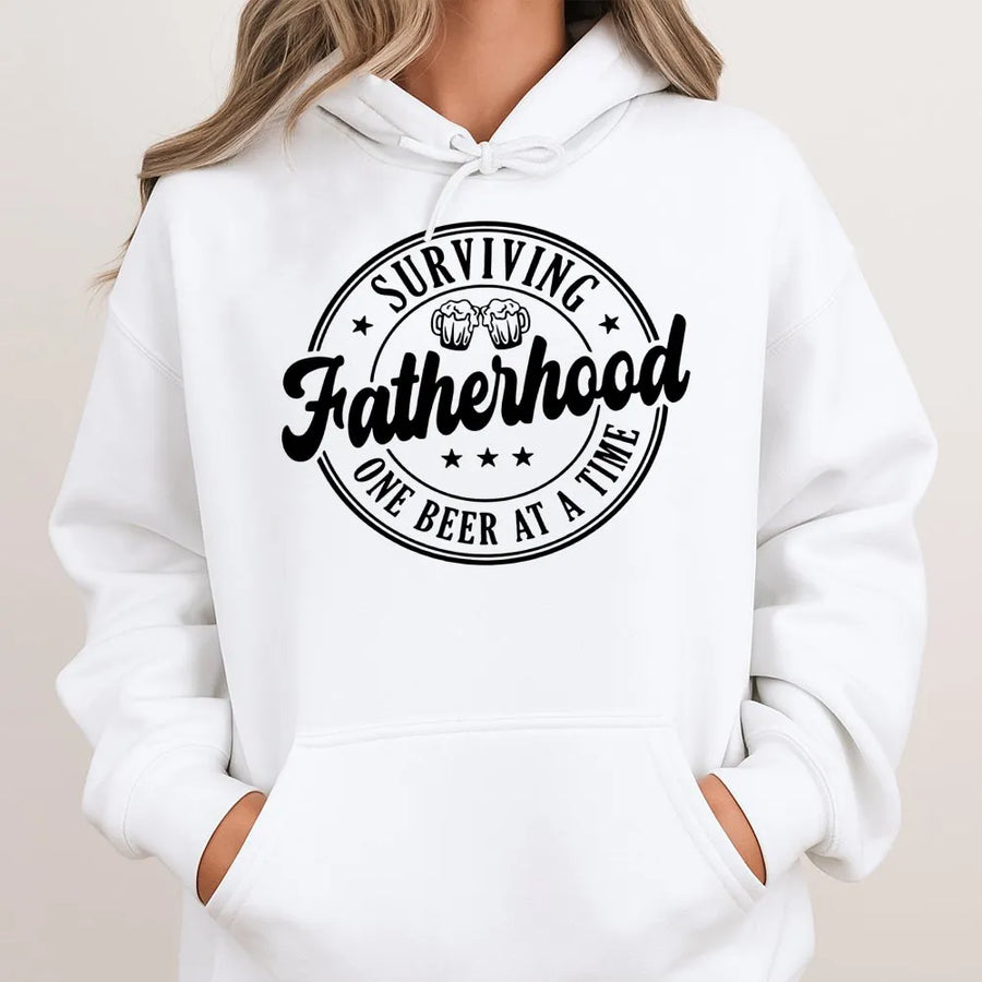 Surviving Fatherhood Hoodie | Funny Beer Lover Graphic Print | Premium Cotton-Blend Pullover | Unique Dad Gift For Father's Day 2026 Birthday