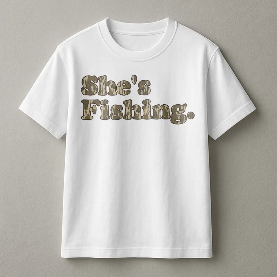 She's Fishing Camo T-Shirt | Retro Woodland Font Design | Premium 100% Cotton | Women's Outdoor Apparel and Fishing Gift for Her