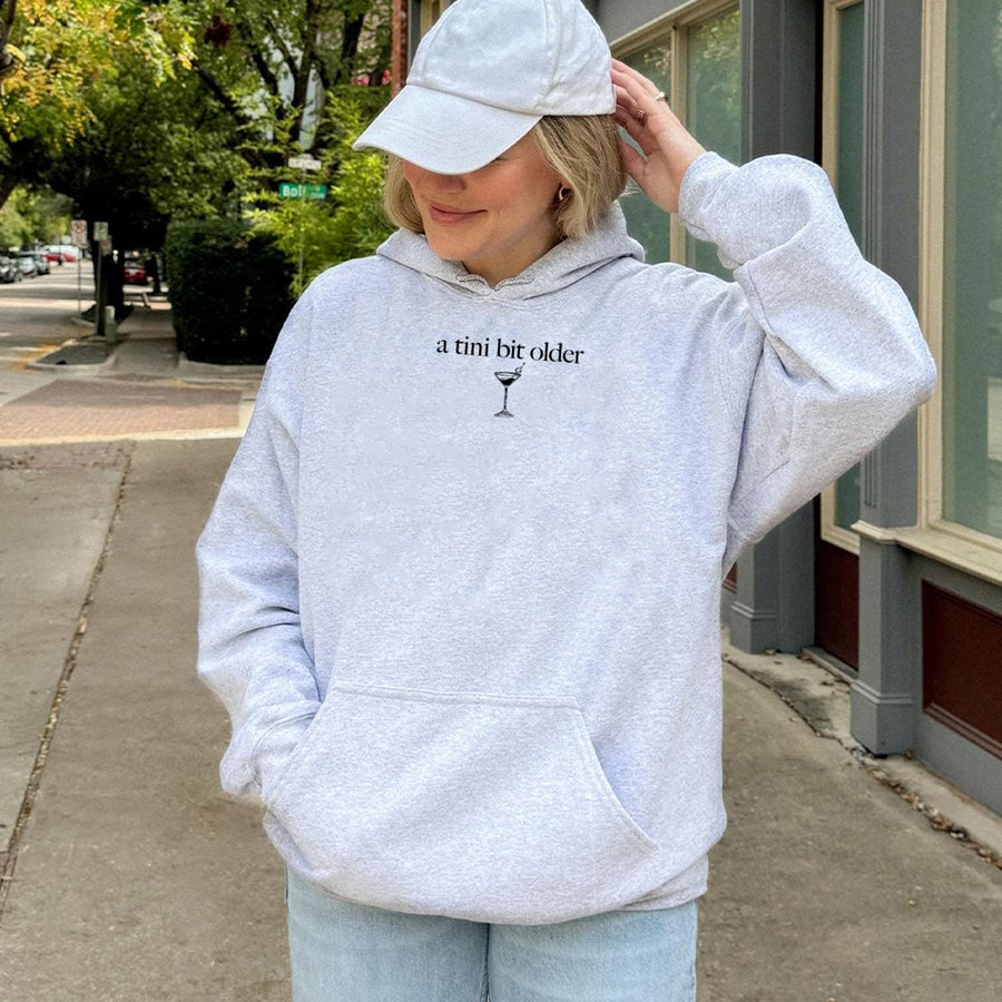 A Tini Bit Older Hoodie | Funny Martini Birthday Graphic | Premium Cotton Blend Unisex Sweatshirt | Gift For Her And Cocktail Lovers