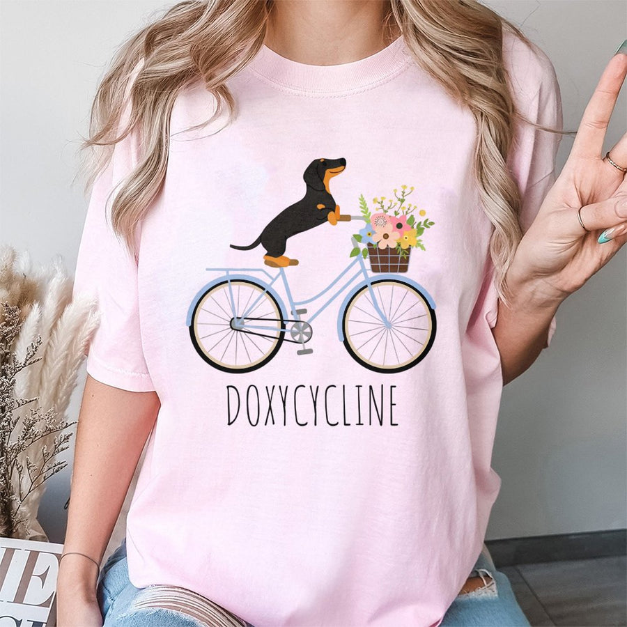 Dachshund Bicycle T-Shirt | Doxycycline Pharmacy Pun Graphic | Premium Cotton Unisex Tee | Gift for Pharmacists Pharmacy Techs