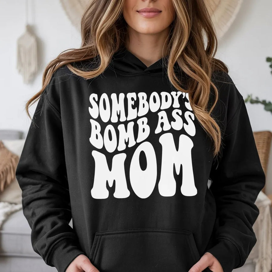 Somebody's Bomb Ass Mom Hoodie | Retro Wavy Typography Graphic | Soft Cotton-Polyester Blend | Trendy Mother's Day 2026 Gift For New Moms