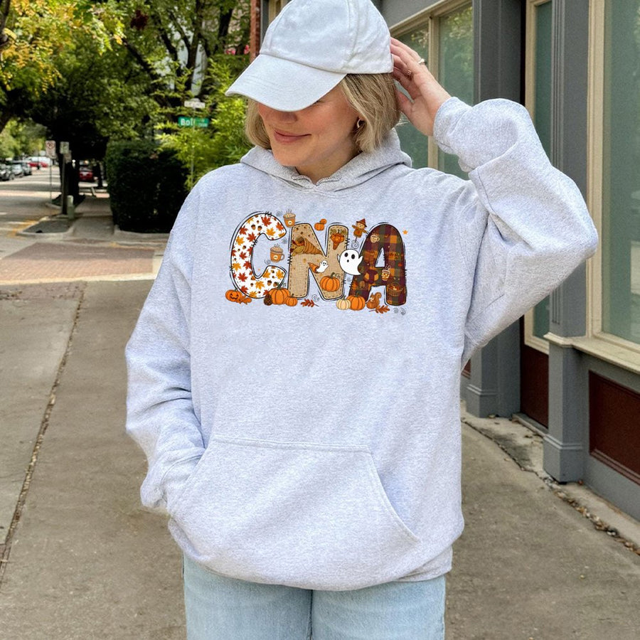 CNA Fall Halloween Hoodie | Autumn Pumpkin Graphic Sweatshirt | Premium Cotton-Blend Apparel | Perfect Gift for Certified Nursing Assistants