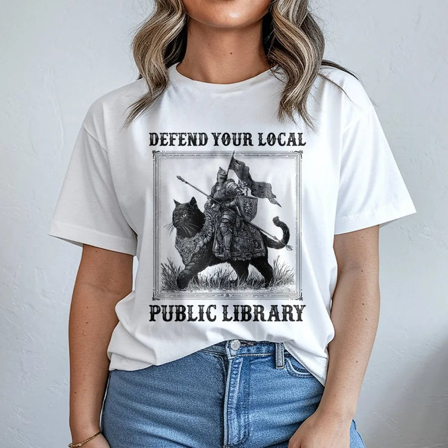 Defend Your Local Public Library T-Shirt | Medieval Knight Riding Black Cat Graphic | Premium 100% Cotton | Funny Book Lover Gift for Readers