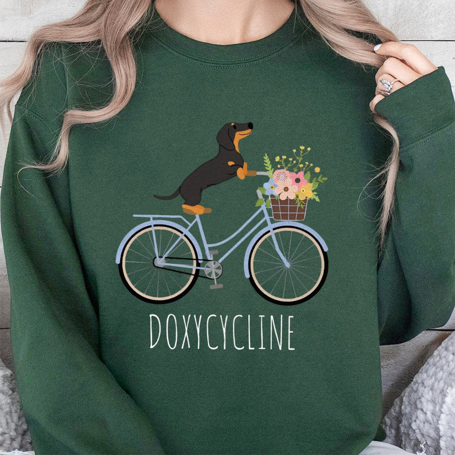 Doxycycline Pharmacy Pun Sweatshirt | Cute Dachshund Riding Bicycle Graphic | Premium Cotton Blend | Funny Gift for Pharmacists and Vet Techs