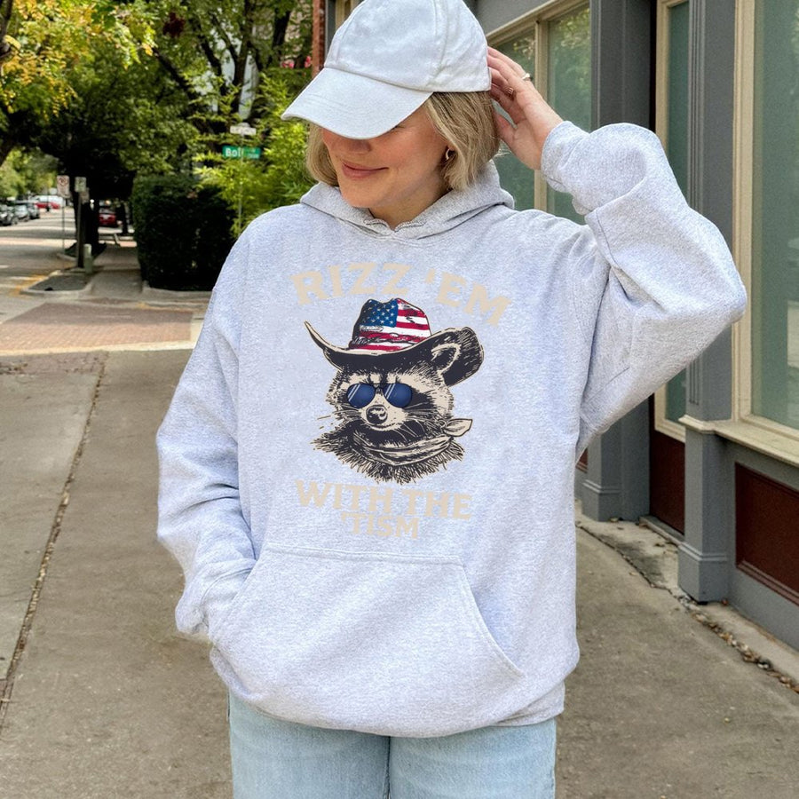 Rizz Em With The Tism Hoodie | Cowboy Raccoon Graphic Print | Soft Cotton-Blend Premium Pullover | Funny Neurodivergent Gift for Adults