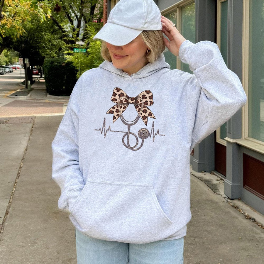 Nurse Hoodie With Leopard Bow Stethoscope | Cute Coquette Heartbeat Nursing Graphic | Cotton-Blend Comfort | Gift For Registered Nurse & Nursing Student