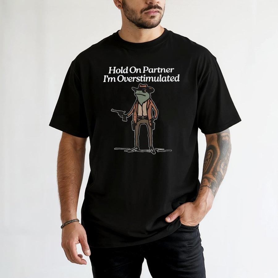 Hold On Partner I'm Overstimulated Frog T-Shirt | Funny Cowboy Toad Graphic Tee | 100% Cotton Premium Quality | Gift for Introverts & Meme Lovers