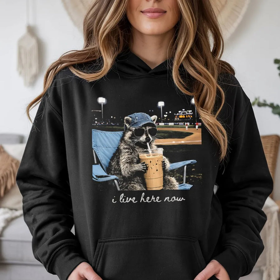 Funny Raccoon Baseball Hoodie | 'I Live Here Now' Graphic Tee | Soft Cotton Unisex Tee | Gift for Baseball Mom or Softball Dad Tournament Fan