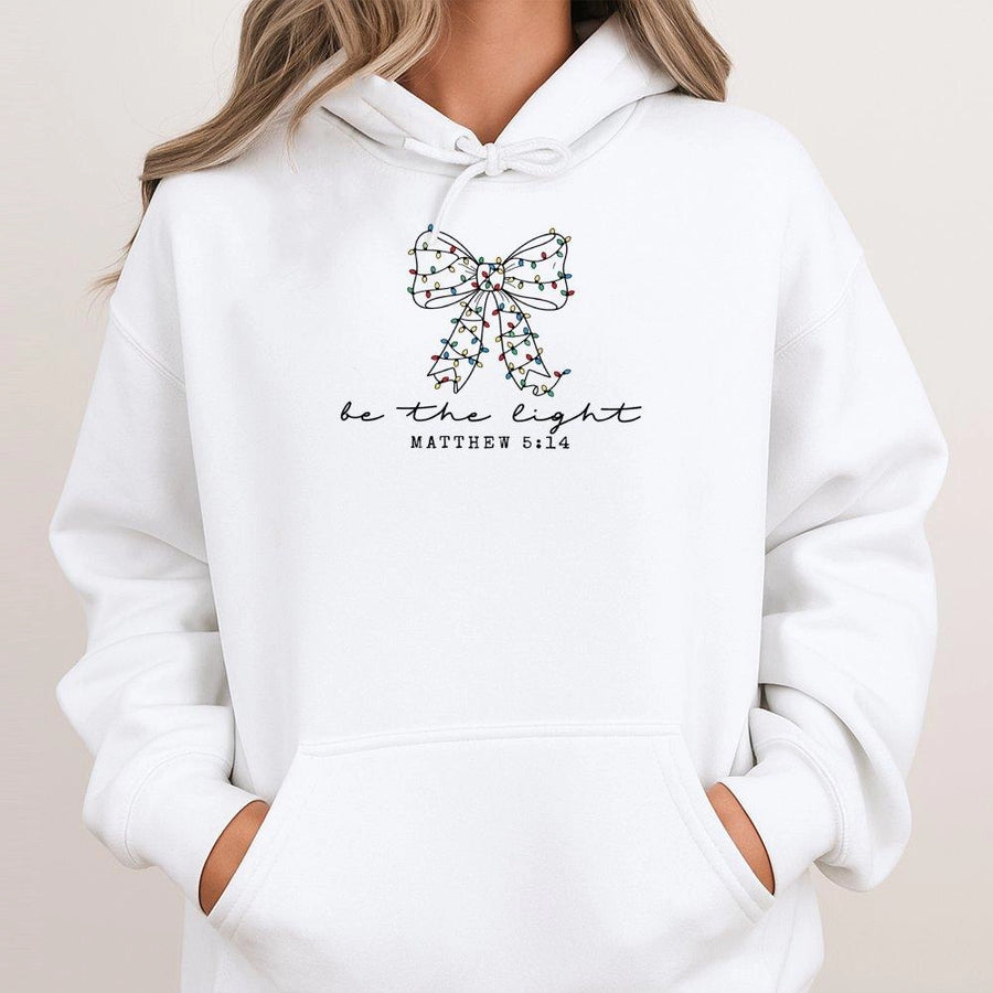 Be The Light Hoodie | Matthew 5:16 Christmas Bow Graphic | Soft Cotton Blend | Religious Christian Gift For Women & Teens