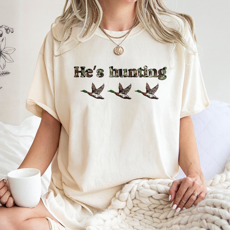 He's Hunting Duck T-Shirt | Camo Text Graphic Design | Premium 100% Cotton | Wildlife Gift for Hunter and Outdoorsman