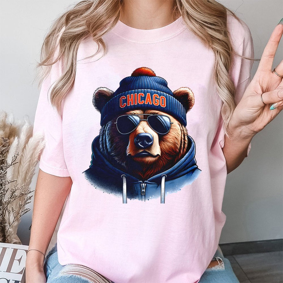 Chicago Bear Wearing Sunglasses, A Blue Beanie With An Orange Pom-Pom, And A Blue T-Shirt
