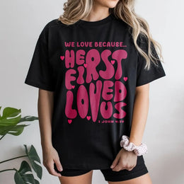We Love Because He First Loved Us T-Shirt | Retro Groovy Bible Verse Graphic | Premium 100% Cotton Tee | Christian Gift for Women and Men