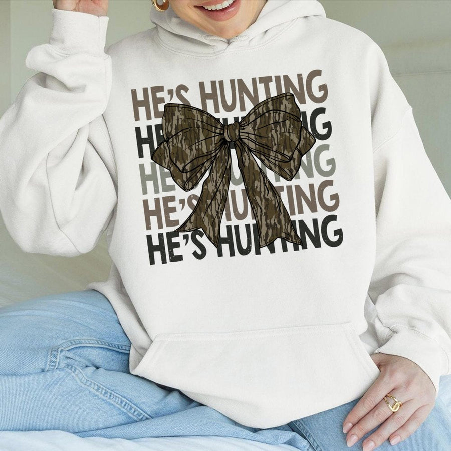 He's Hunting Camo Bow Hoodie | Coquette Aesthetic Graphic Design | Soft Cotton-Polyester Blend | Trendy Gift for Women & Deer Hunting Season Fans