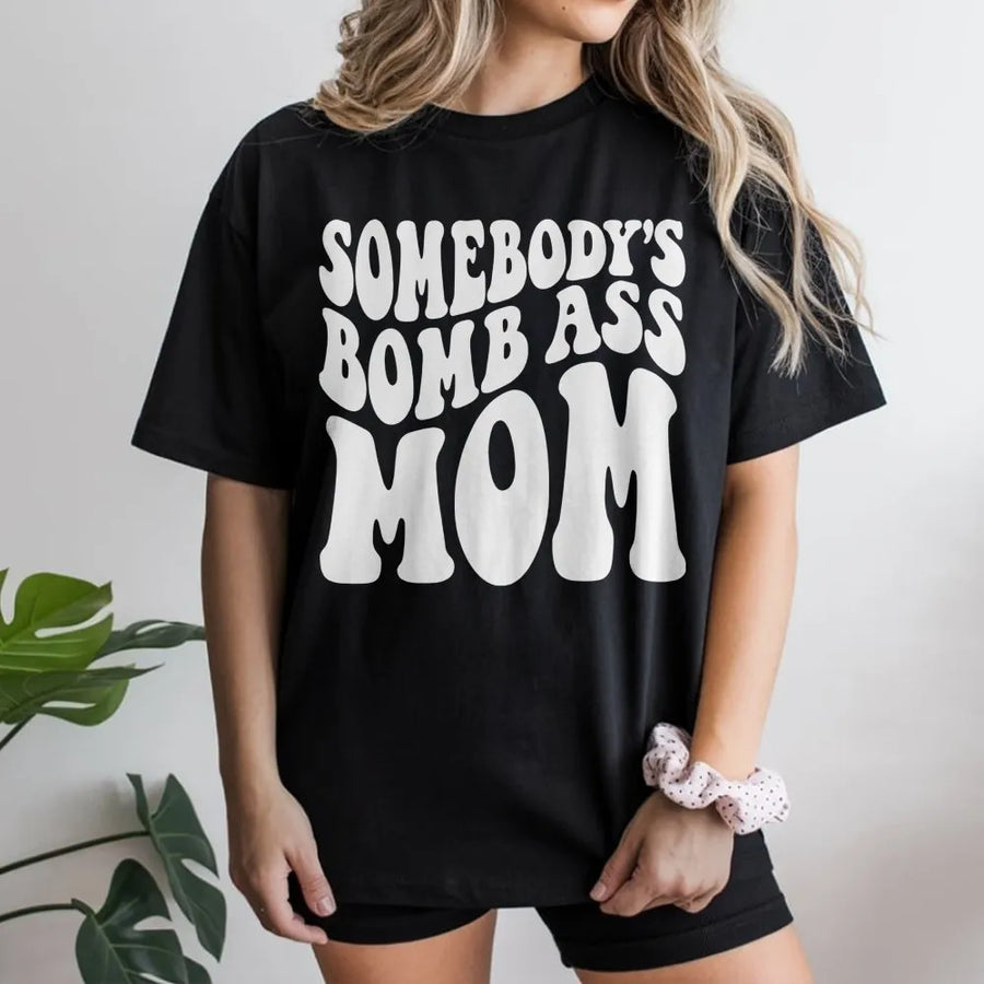 Somebody's Bomb Ass Mom T-Shirt | Retro Wavy Typography Graphic Tee | Premium 100% Cotton | Funny Mother's Day 2026 Gift for New Mom