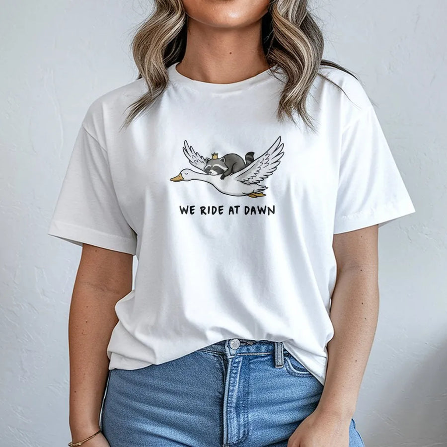 We Ride At Dawn Raccoon Goose T-Shirt | Funny Animal Graphic Print | Premium Soft Cotton Unisex Tee | Cute Critter Gift for Men and Women
