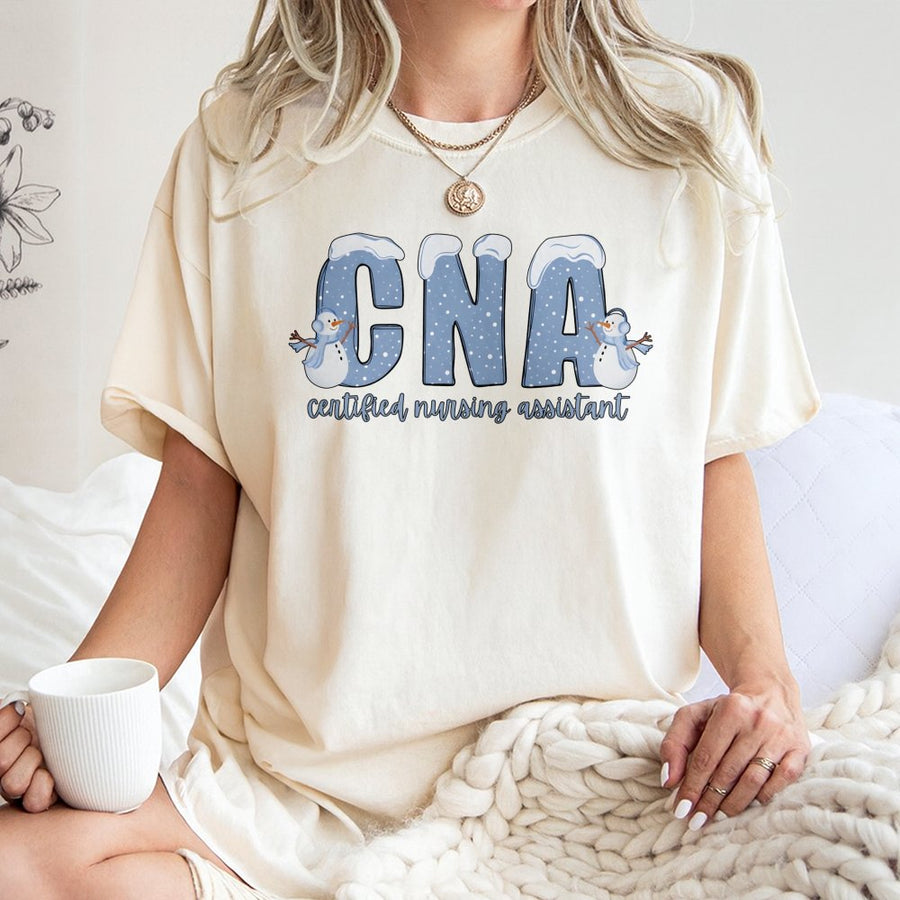 CNA T-Shirt | Winter Snowman Nursing Assistant Graphic | Premium Cotton Gift for Nurses | Holiday Medical Professional Work Shirt