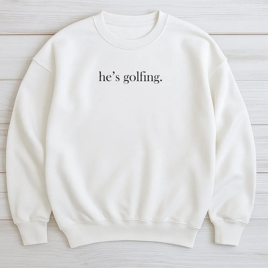 He's Golfing Sweatshirt | Funny Minimalist Golfer Quote Tee | Premium Soft Cotton Shirt | Gift for Golf Wife or Mom