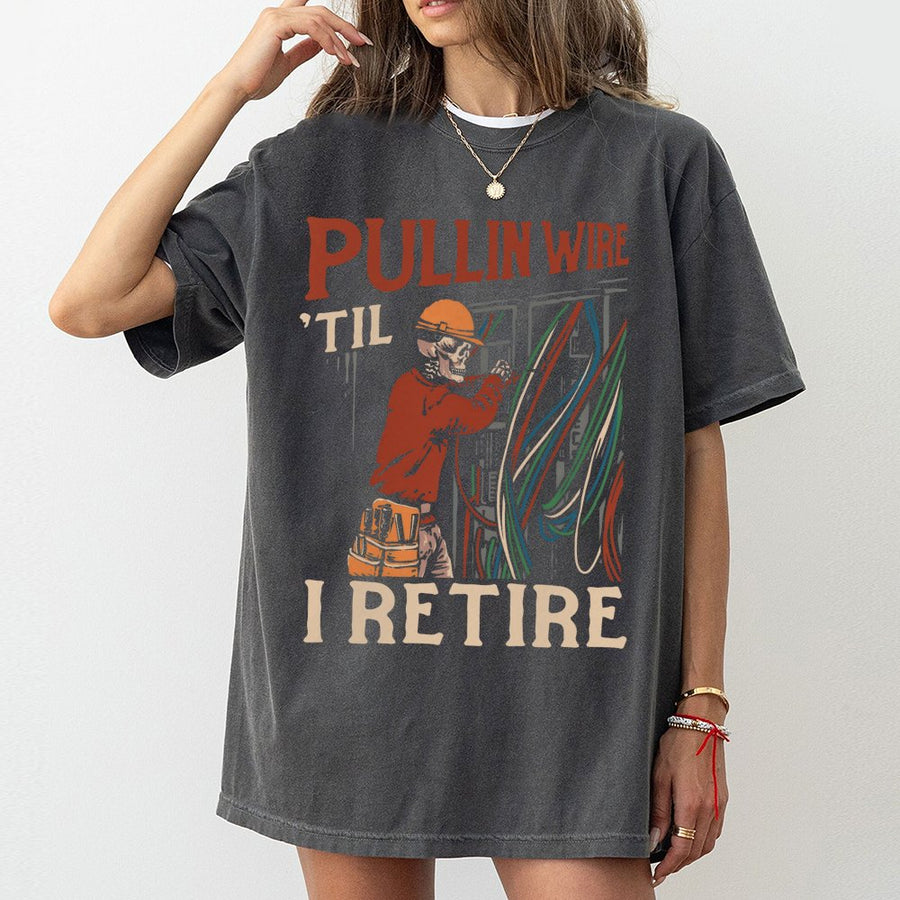 Electrician T-Shirt | Pullin Wire 'Til I Retire Skeleton Graphic | 100% Cotton Premium Tee | Funny Blue Collar Retirement Gift for Tradesmen
