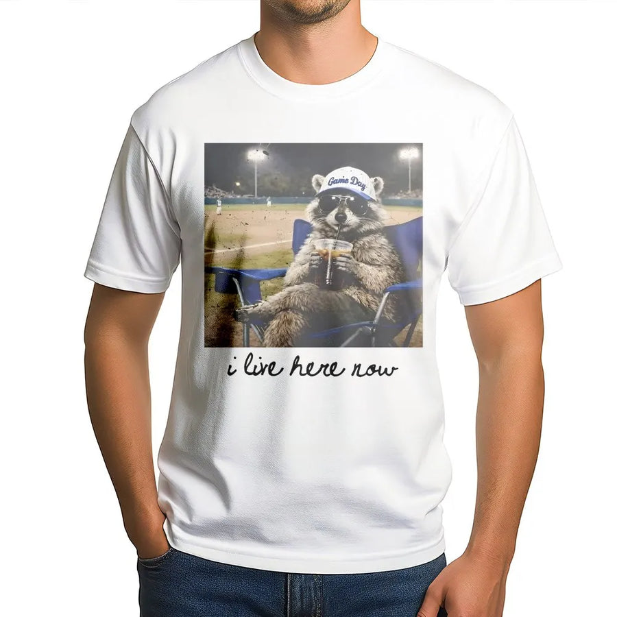 I Live Here Now Raccoon Shirt | Funny Travel Ball Parent Life Meme | Soft 100% Cotton Tee | Gift for Baseball Mom or Softball Dad