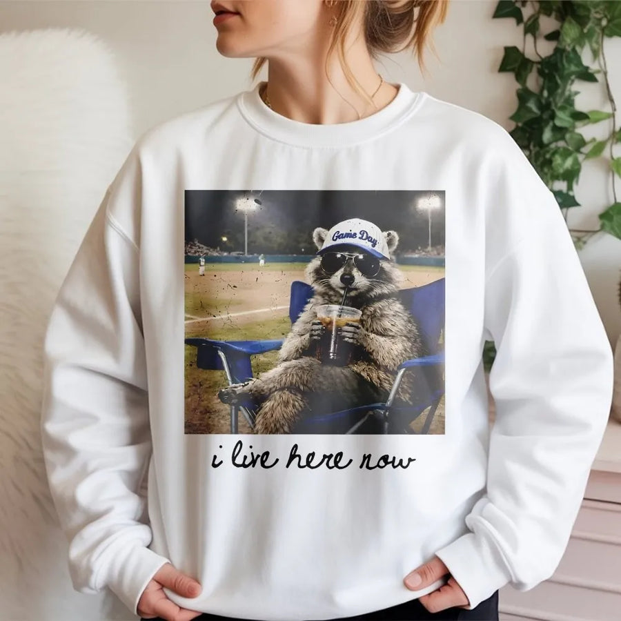 I Live Here Now Raccoon Shirt | Funny Travel Ball Parent Life Meme | Soft 100% Cotton Tee | Gift for Baseball Mom or Softball Dad