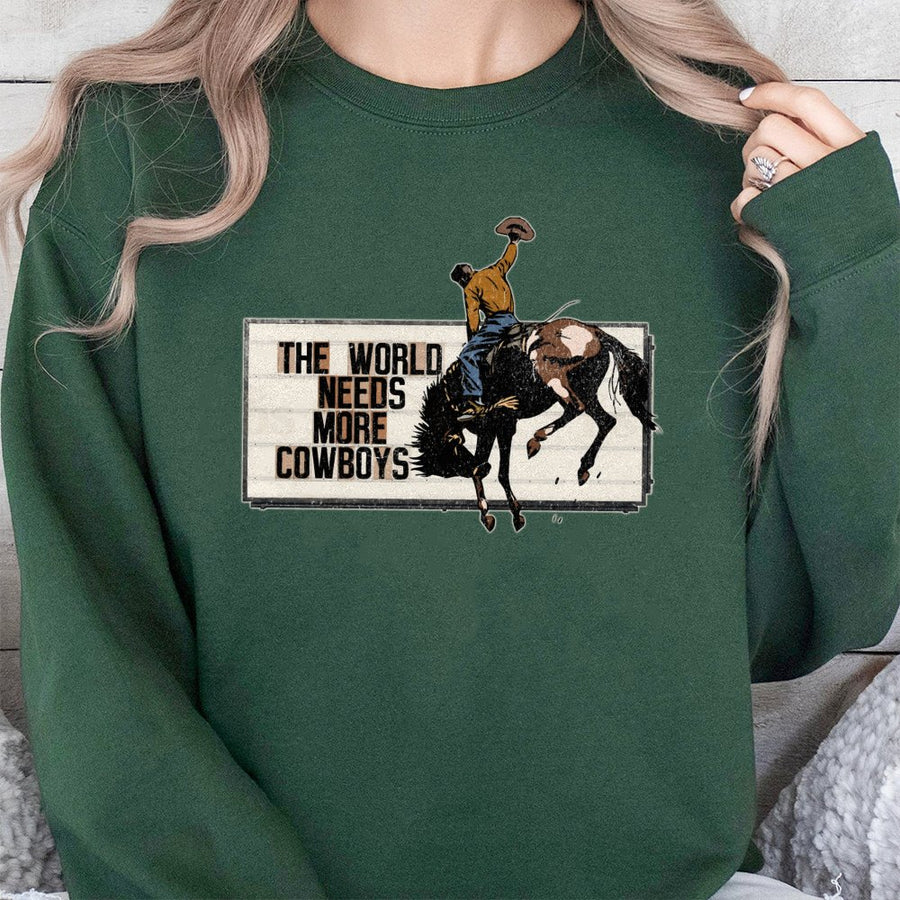 The World Needs More Cowboys Sweatshirt | Vintage Rodeo Graphic Western Print | Cotton Blend Crewneck | Unisex Country Western Gift for Cowgirl