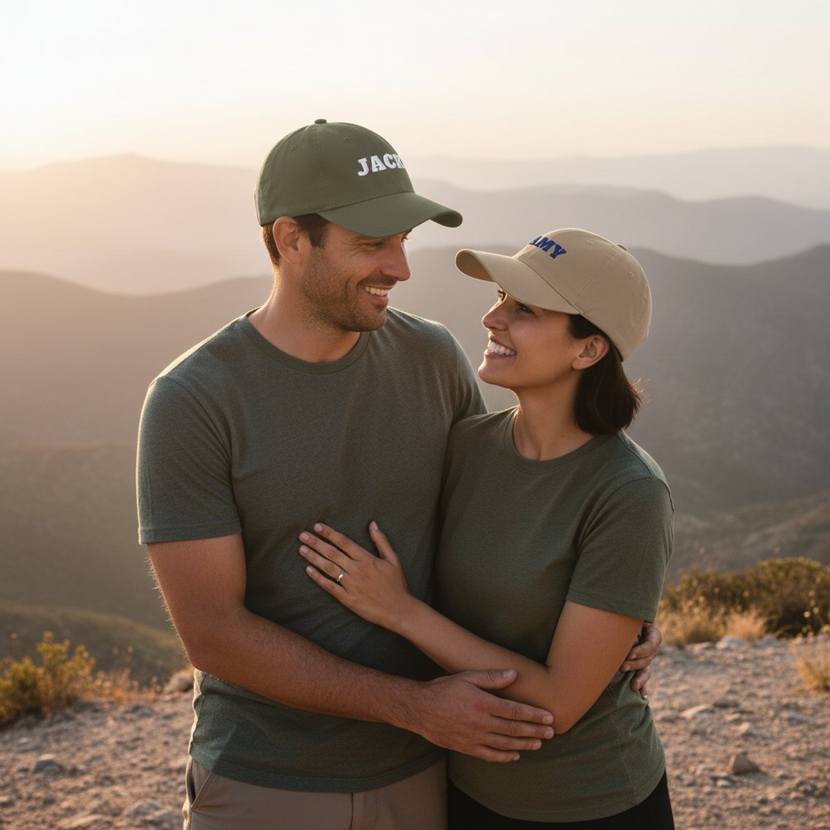 A couple on a hiking trail wearing matching embroidered caps with their names