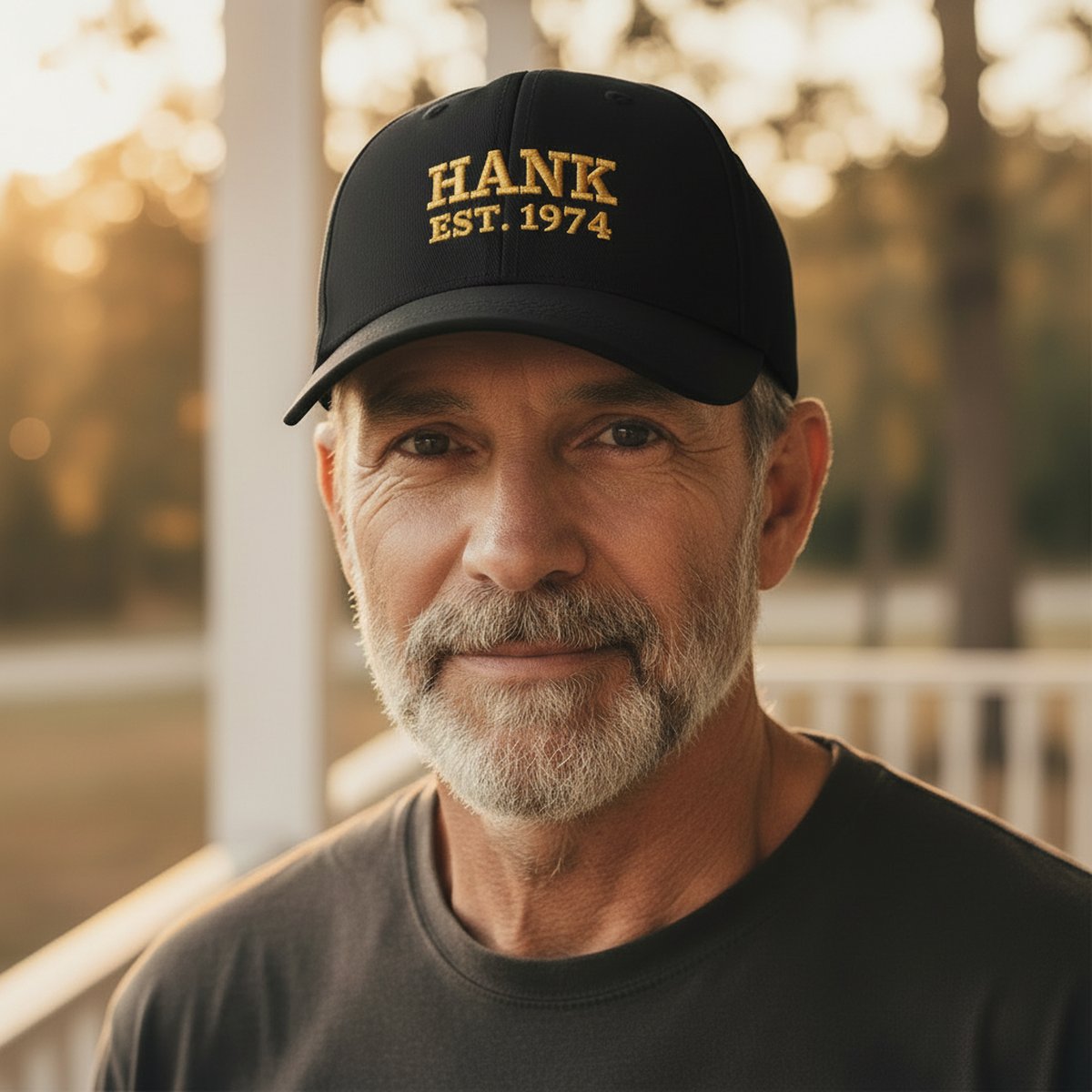 A man wearing a black embroidered cap with his name stitched across the front
